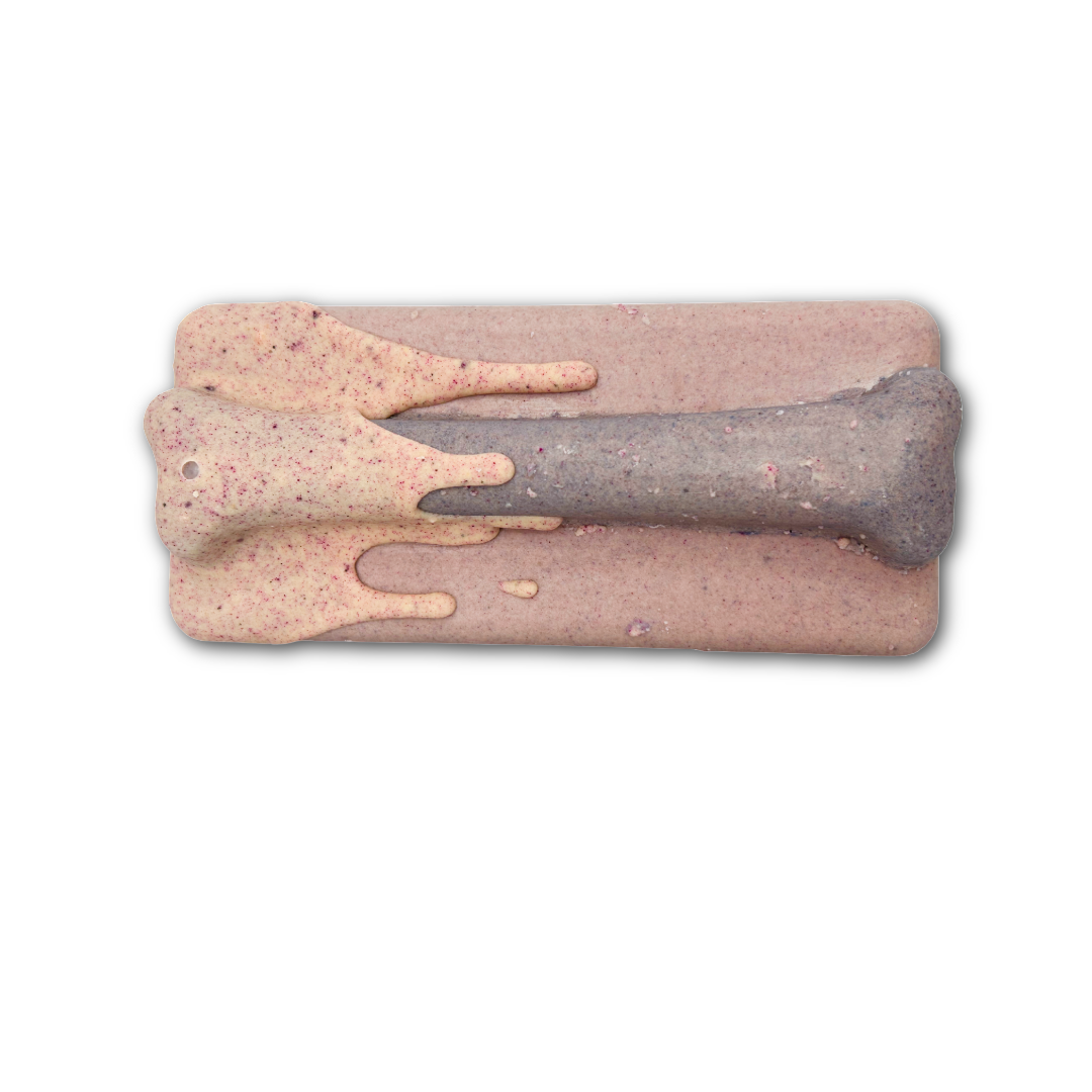 Pink chocolate bar with blueish bone on top, with pink dripping drizzle on one end. On a white background.
