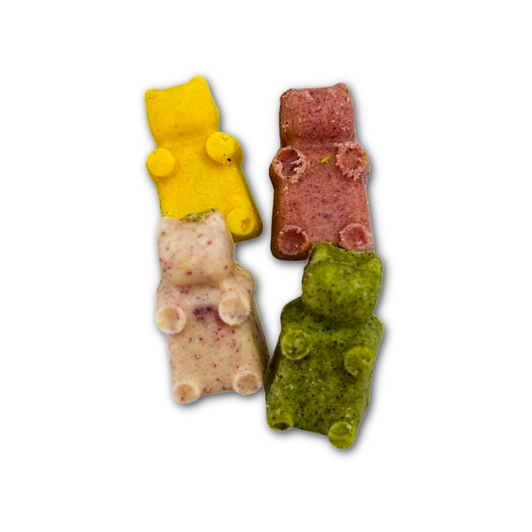 Four colourful gummy bear shaped chocolates on a white background.