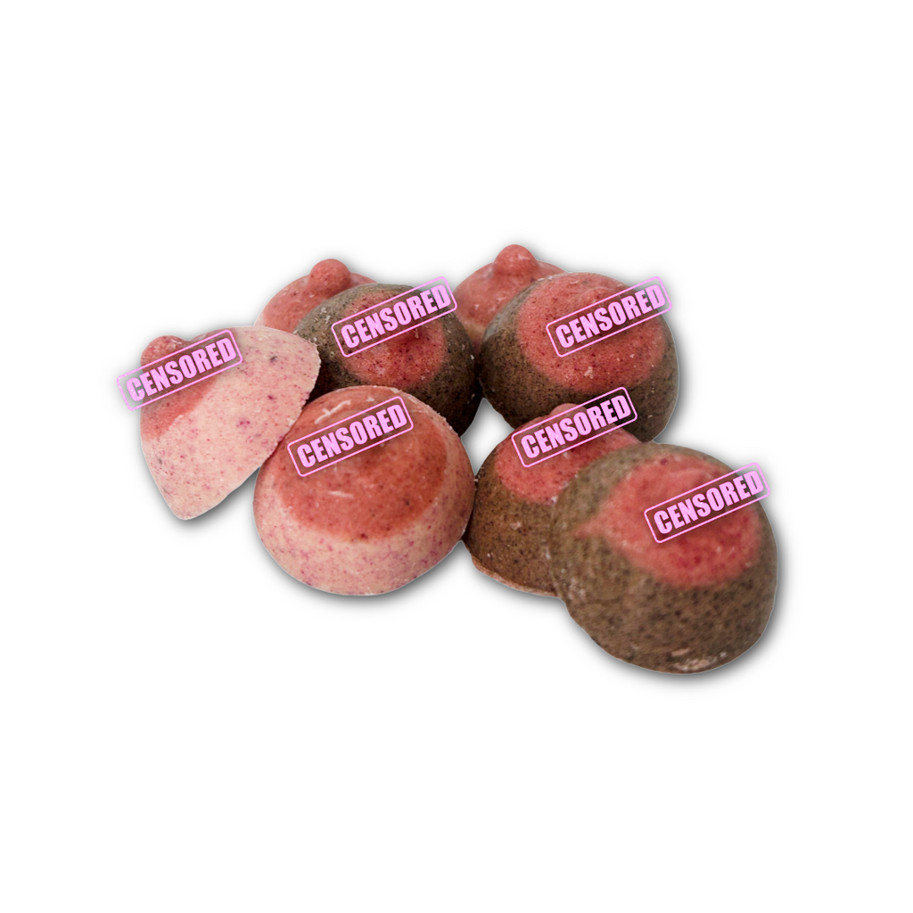 Pink and brown mini boob shaped chocolates on a white background.
