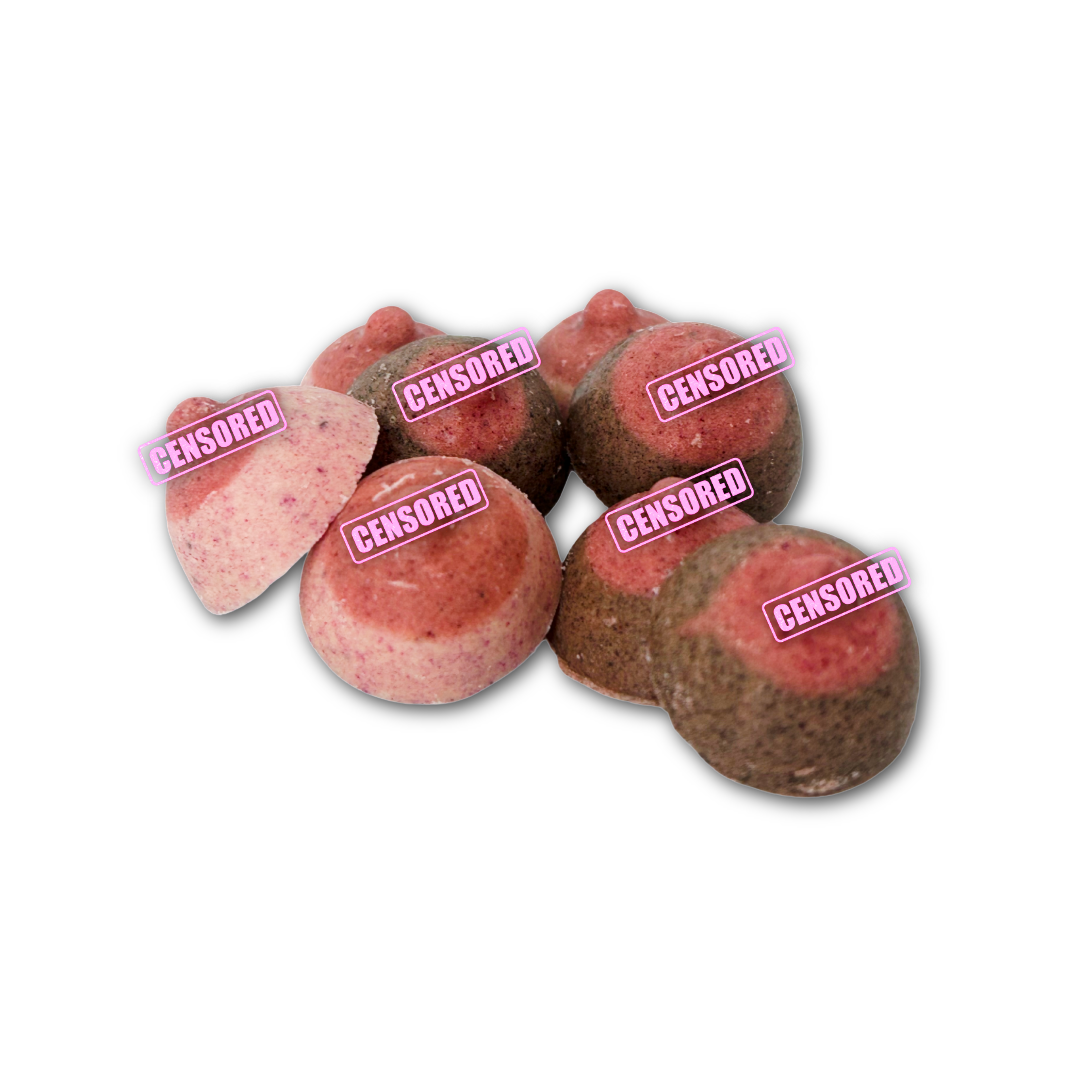 Pink and brown mini boob shaped chocolates on a white background.